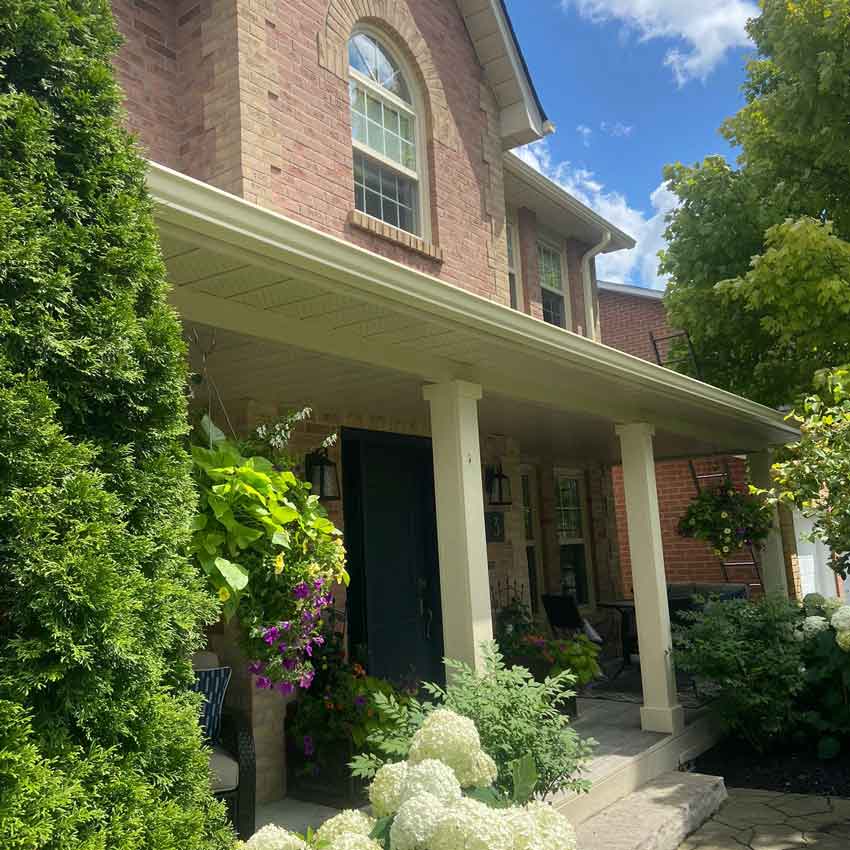 House with new gutter installed on porch
